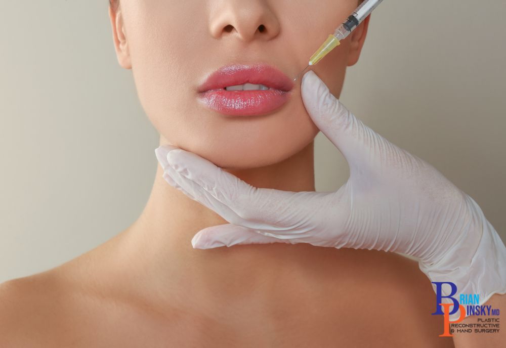 A person receiving a cosmetic treatment as a gloved hand supports their chin, illustrating the transformative power of beauty enhancements with expert precision.