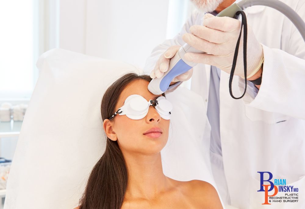 A woman, donning protective eyewear, undergoes a cosmetic laser treatment in a clinic. This advanced cosmetic procedure is expertly administered by a medical professional.