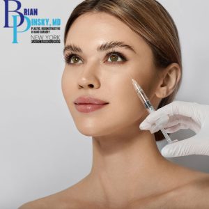 A woman receives Botox in her cheek from a gloved hand, with a medical practice logo visible in the upper left corner.
